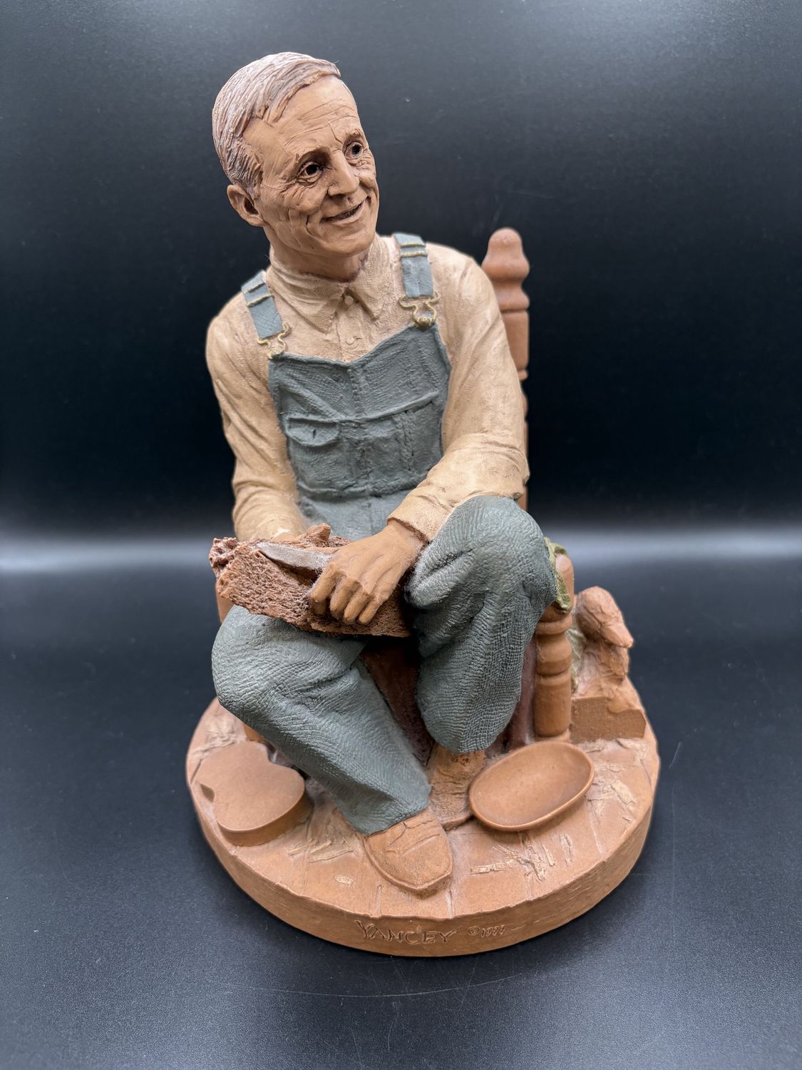Sculpted Figure. USA. Tom Clark. &quot;Uncle Whit.&quot; Man Sitting and Carving Wood. 1999. 9&quot;H
