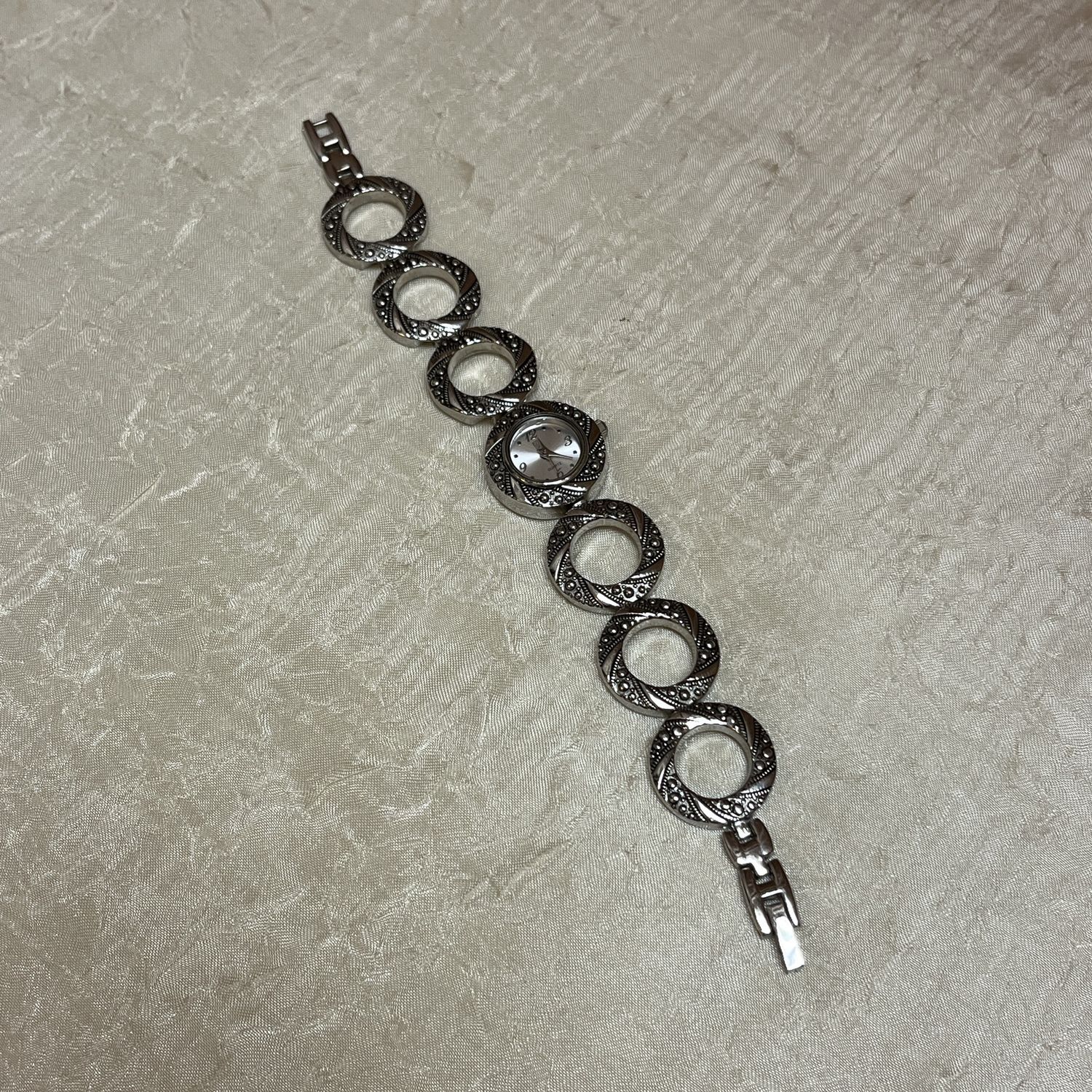 textured silver O watch