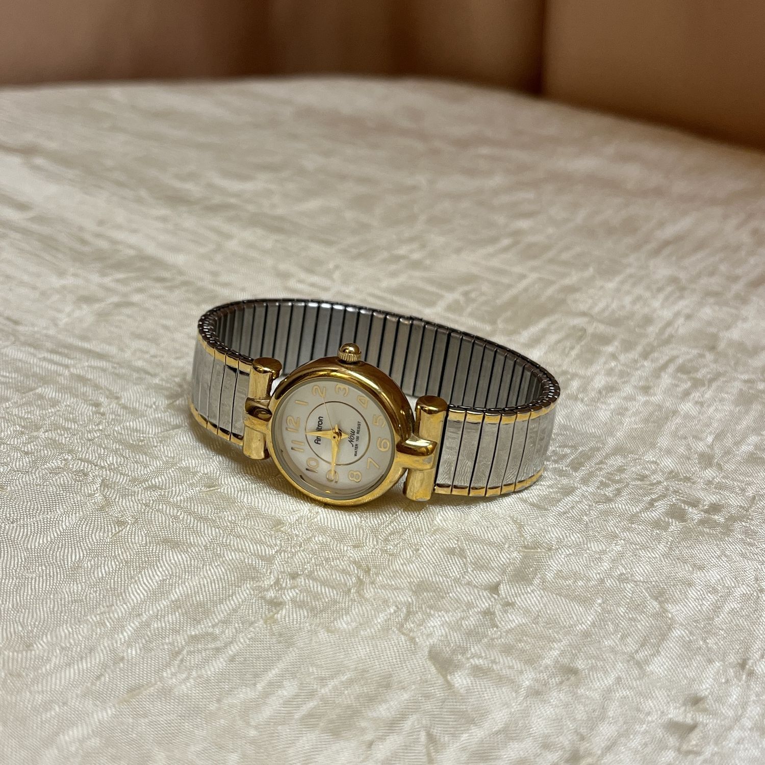 gold and silver elastic watch