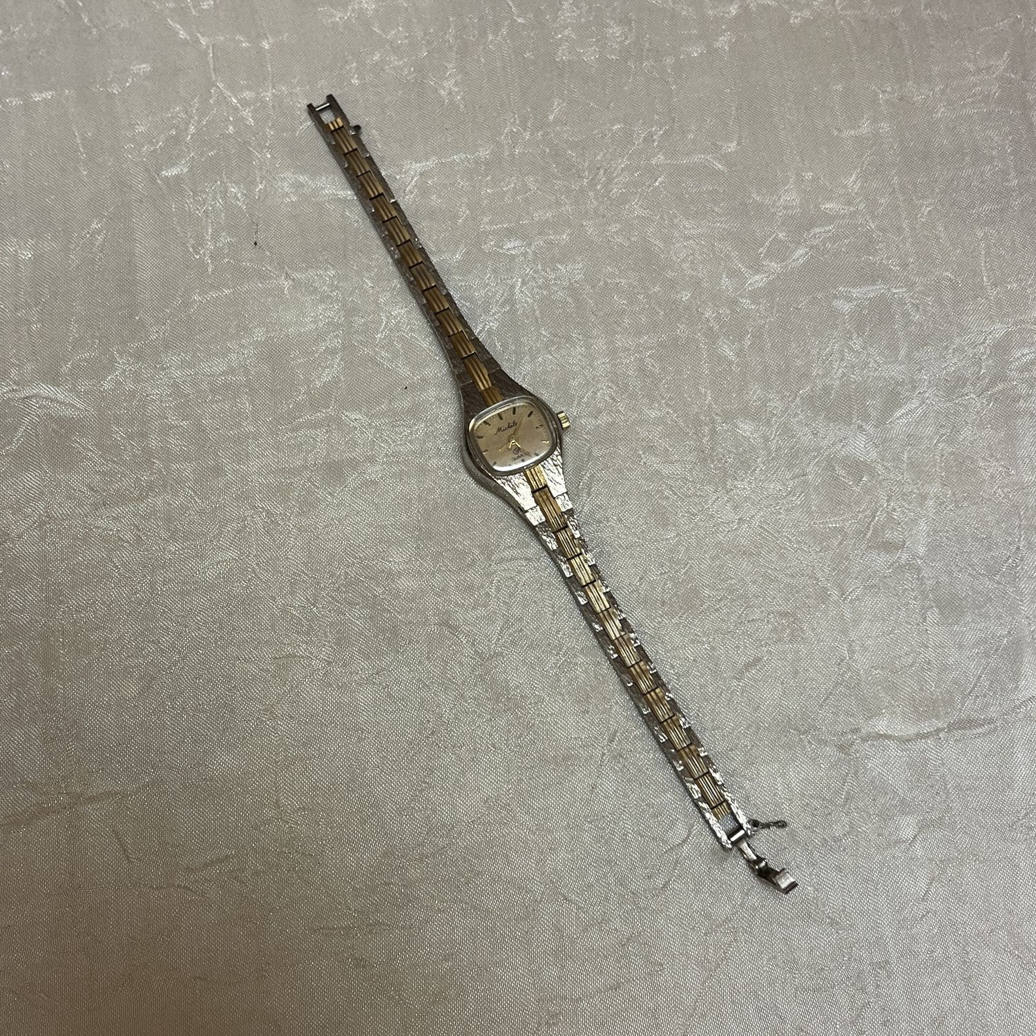 silver and gold mini watch
