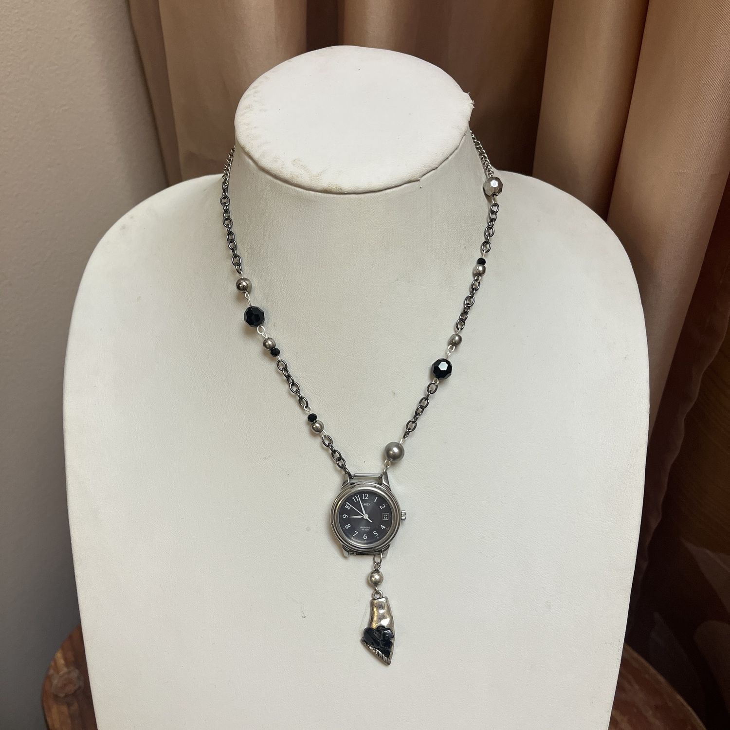 black and silver watch necklace