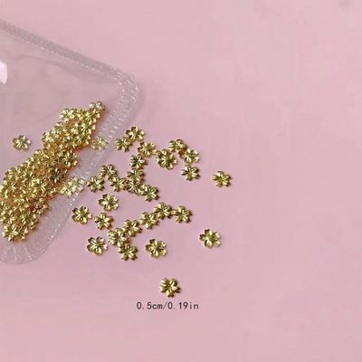 100pcs Gold Flower Nail Art Charms - Cute Mini Alloy Gold Blossom Designs Nail Accessories Solid Color with Cherry Blossom Shape Nail Charms Gold Flower Nail Decorations for Women Manicure Art