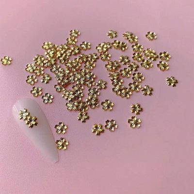 100pcs Gold Flower Nail Art Charms - Cute Mini Alloy Gold Blossom Designs Nail Accessories Solid Color with Cherry Blossom Shape Nail Charms Gold Flower Nail Decorations for Women Manicure Art
