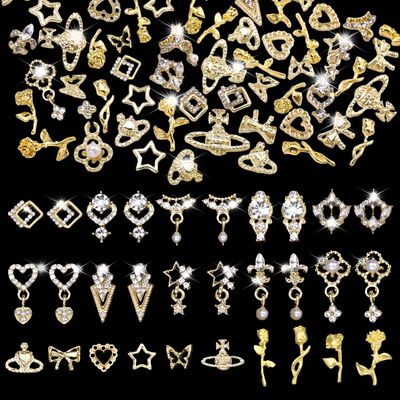 CESUSME 100 Pcs 3D Gold Nail Gems Charms, 20 Style Alloy 3D Dangle Star Nail Jewelry Charms Heart Nail Gems with Rhinestones, 3D Rose Flower Planet Bow Shiny Nail Charms for Nails Art DIY