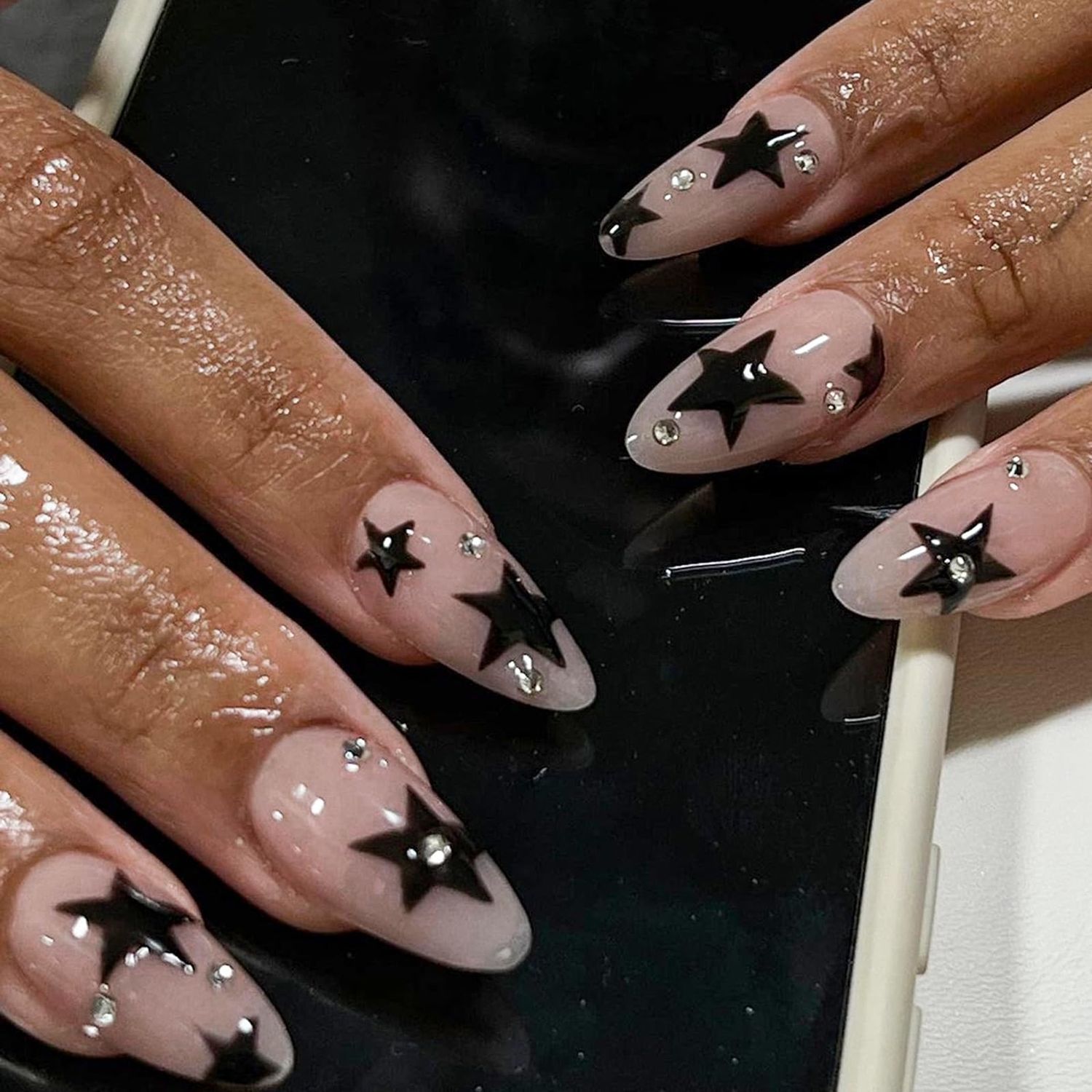 Black Star Press on Nails Medium Almond Fake Nails with Design Rhinestone Stick on Nails Acrylic Nails Star False Nails Glossy Natural Nude Glue on Nails for Women Girls Manicure 24Pcs