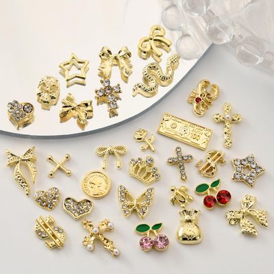 OPMADM 100Pcs Gold Nail Charms and Gems Charms for Nails Design Gold Charms for Nails Metal Bow Cherry Butterfly Cross Heart Star and Flowers