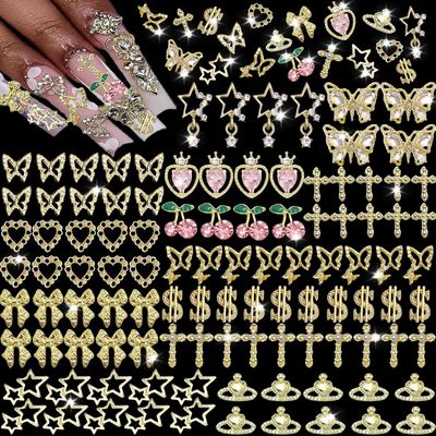 KACHIMOO 106 PCS Gold Nail Charms 3D Nail Art Charms Cherry Butterfly Cross Bow Star Heart Dollar 3D Nail Gems for Women Nail Art DIY Design