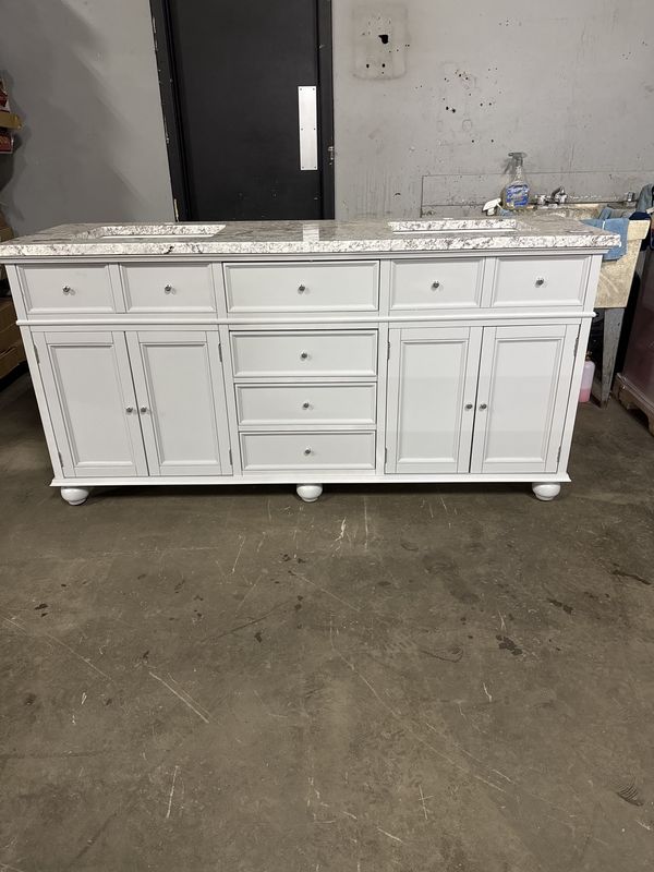 72in. X 22in.  Light gray vanity with granite top and double sinks.