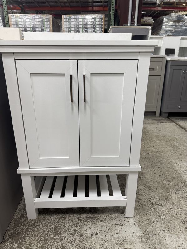 24in. X 19in. White bathroom vanity with top and sink.