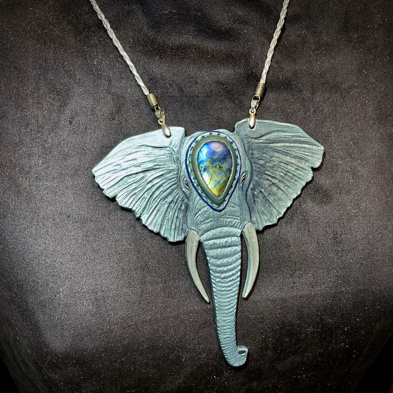 Hand tooled leather elephant pendant with rainbow labradorite