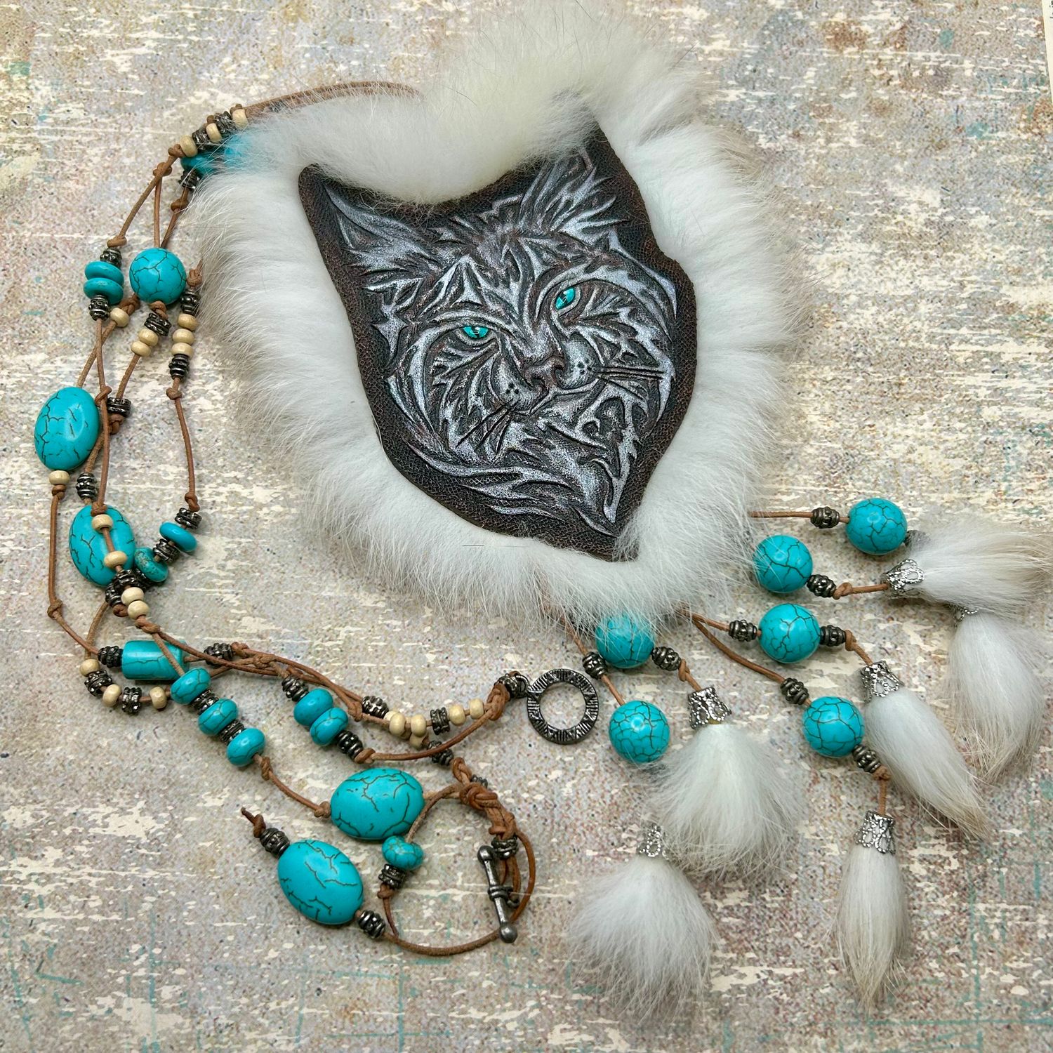 Tooled leather necklace with tribal lynx portrait and rabbit fur