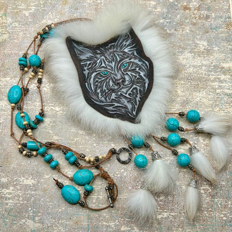 Tooled leather necklace with tribal lynx portrait and rabbit fur