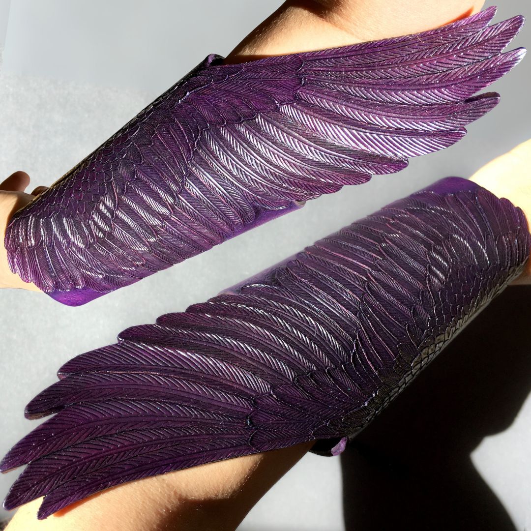 Tooled leather purple wing shaped armguards