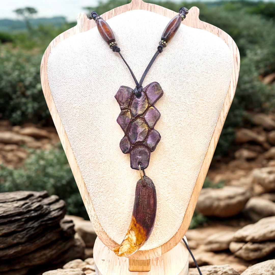 Crocodile leather pendant with boar tooth