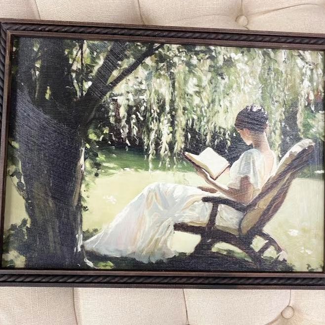 GIRL READING UNDER TREE