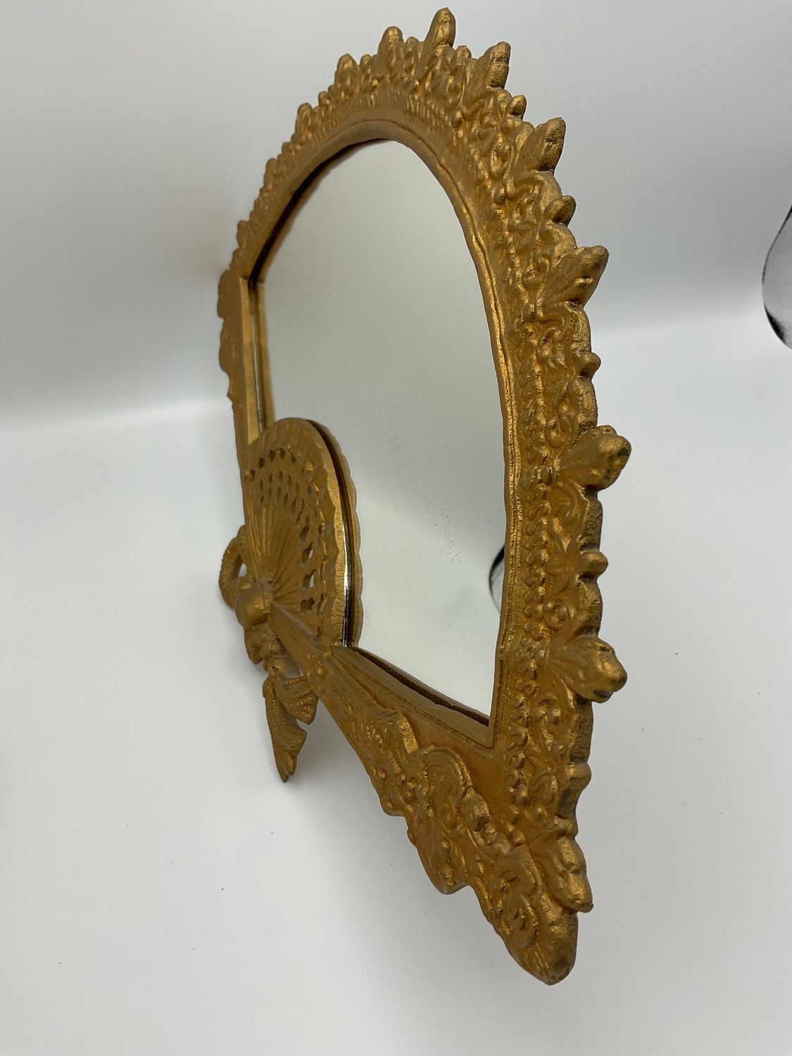 Ornate brass fan mirror