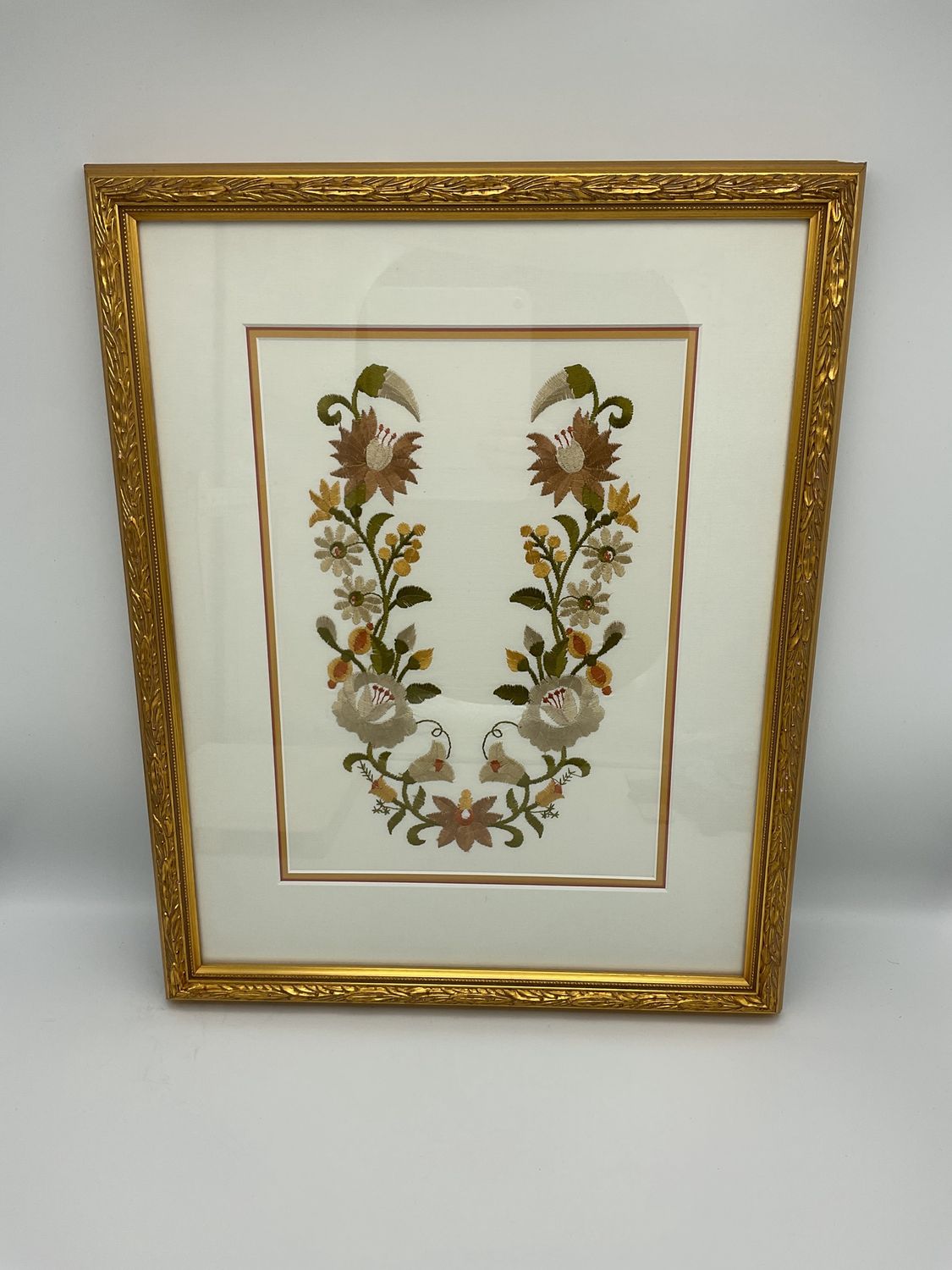 Floral embroidery in gold frame