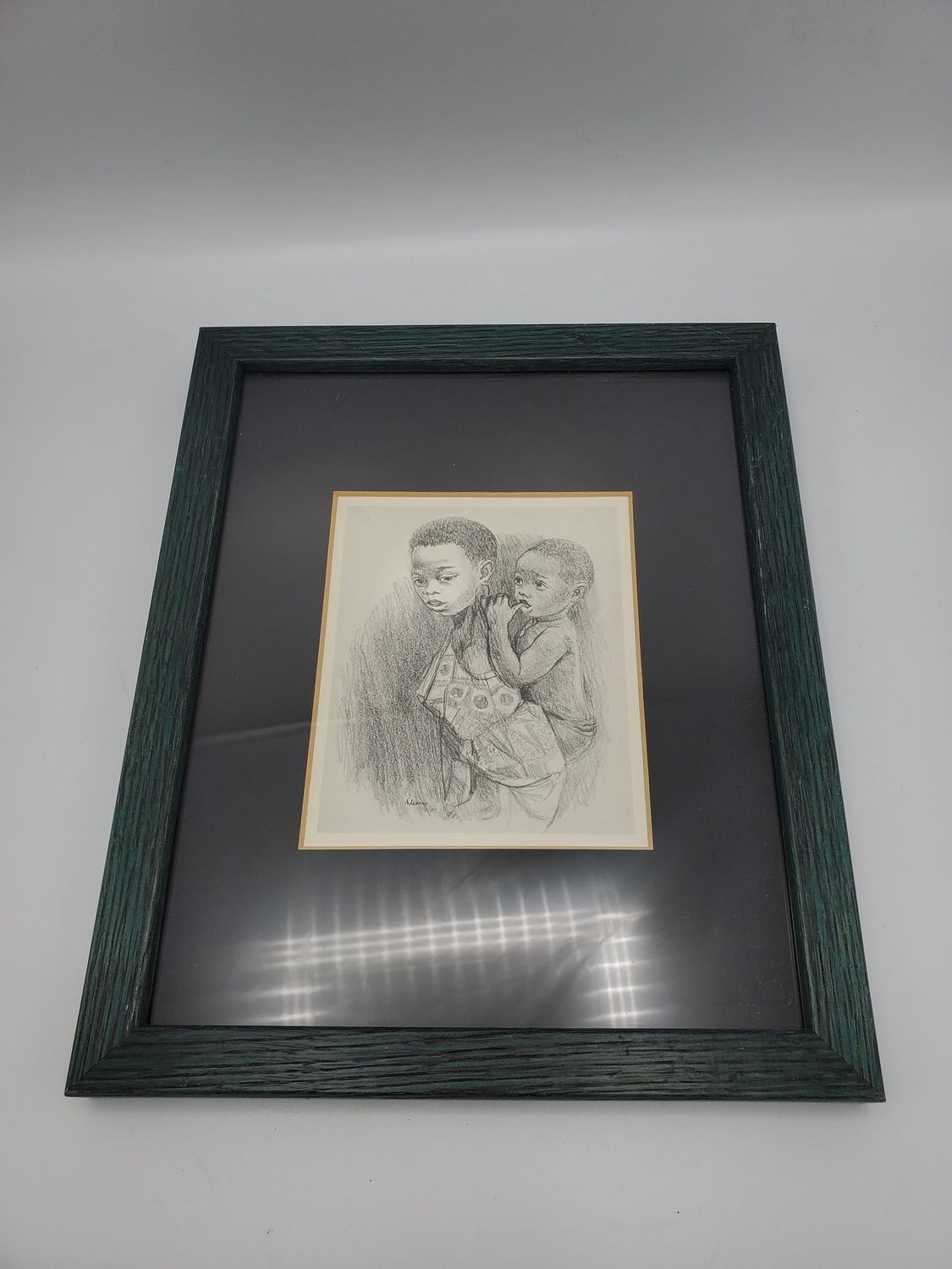 Two siblings drawing signed framed