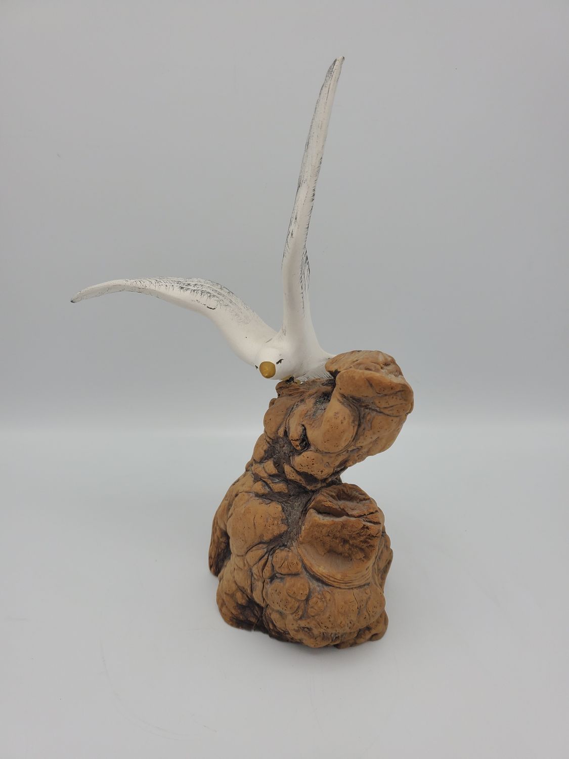 Seagull ceramic figurine on driftwood