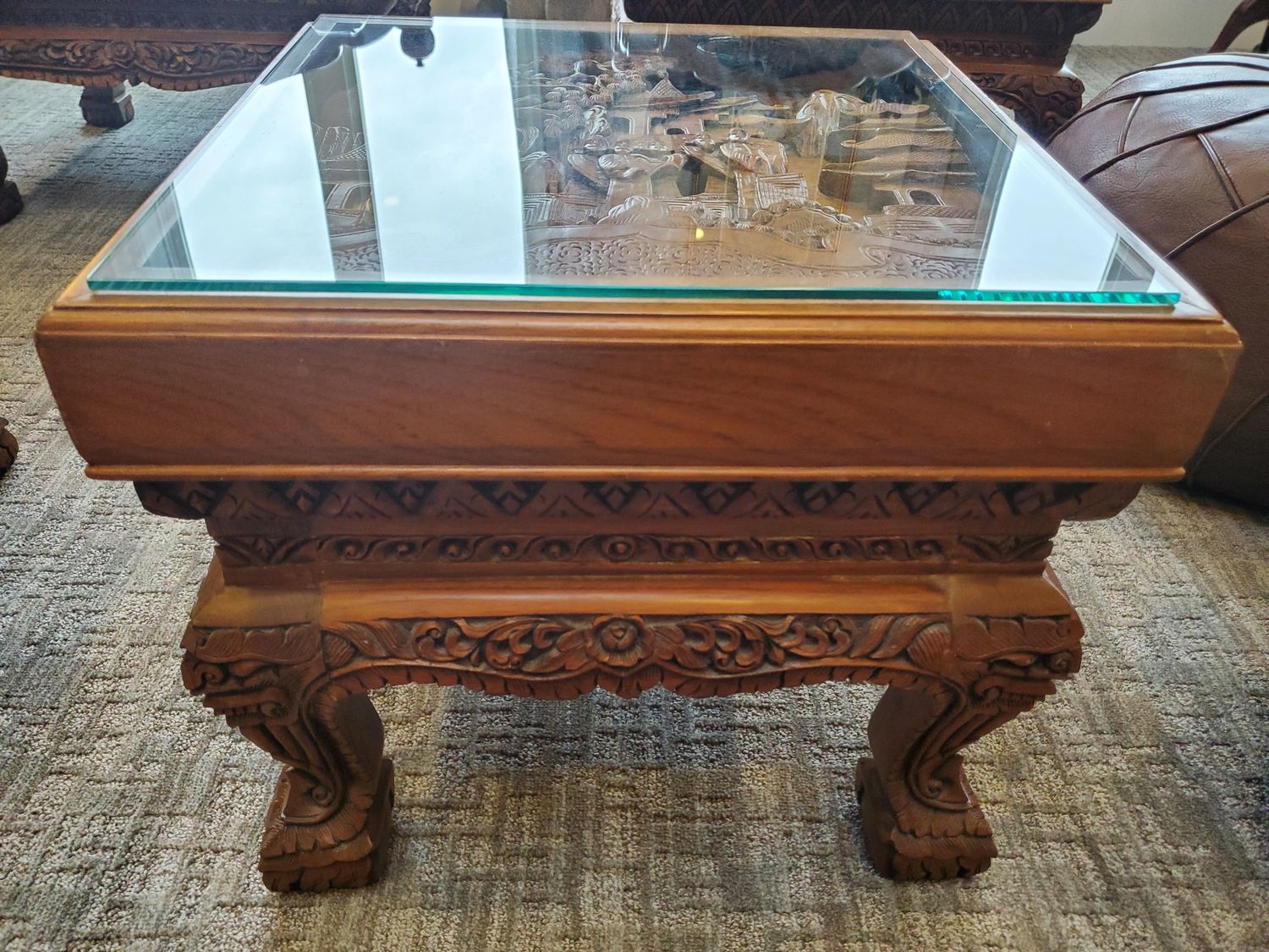 Ornate hand carved coffee table with glass top