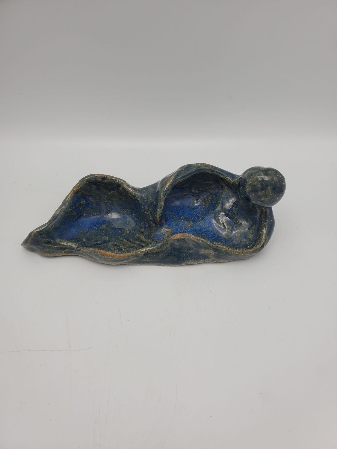 Person laying sculpture