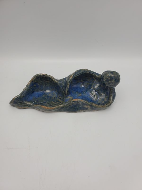 Person laying sculpture