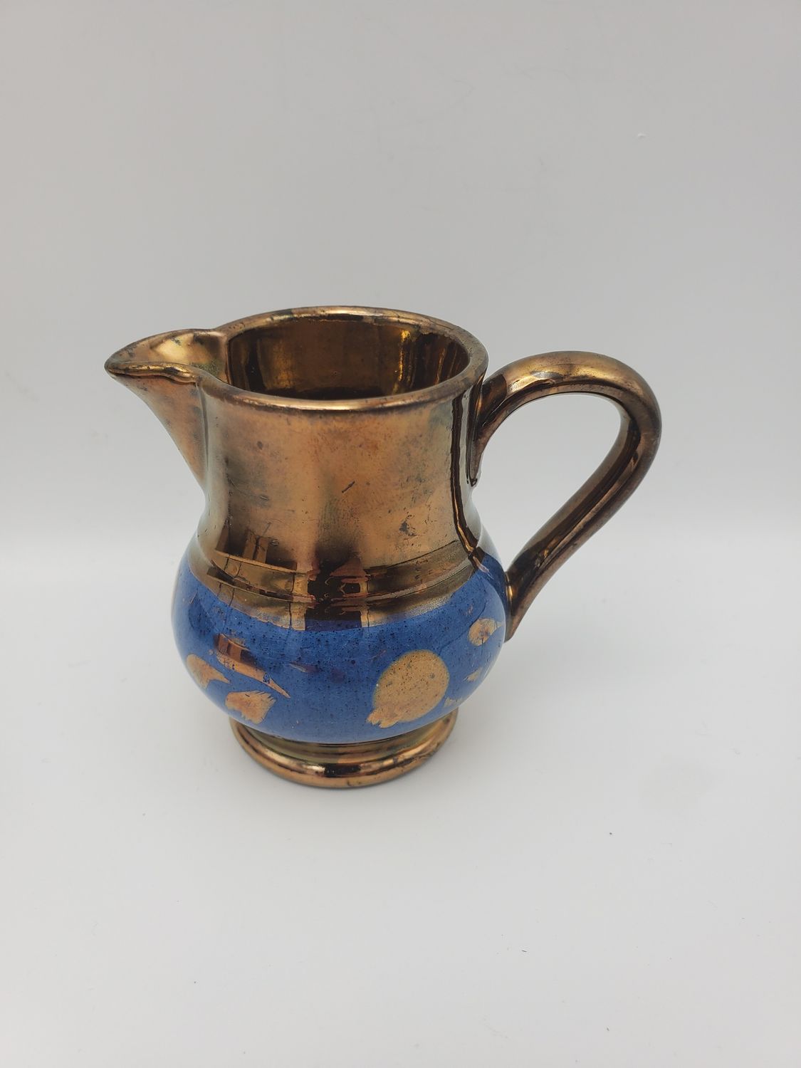 Copper lusterware blue tadpole creamer