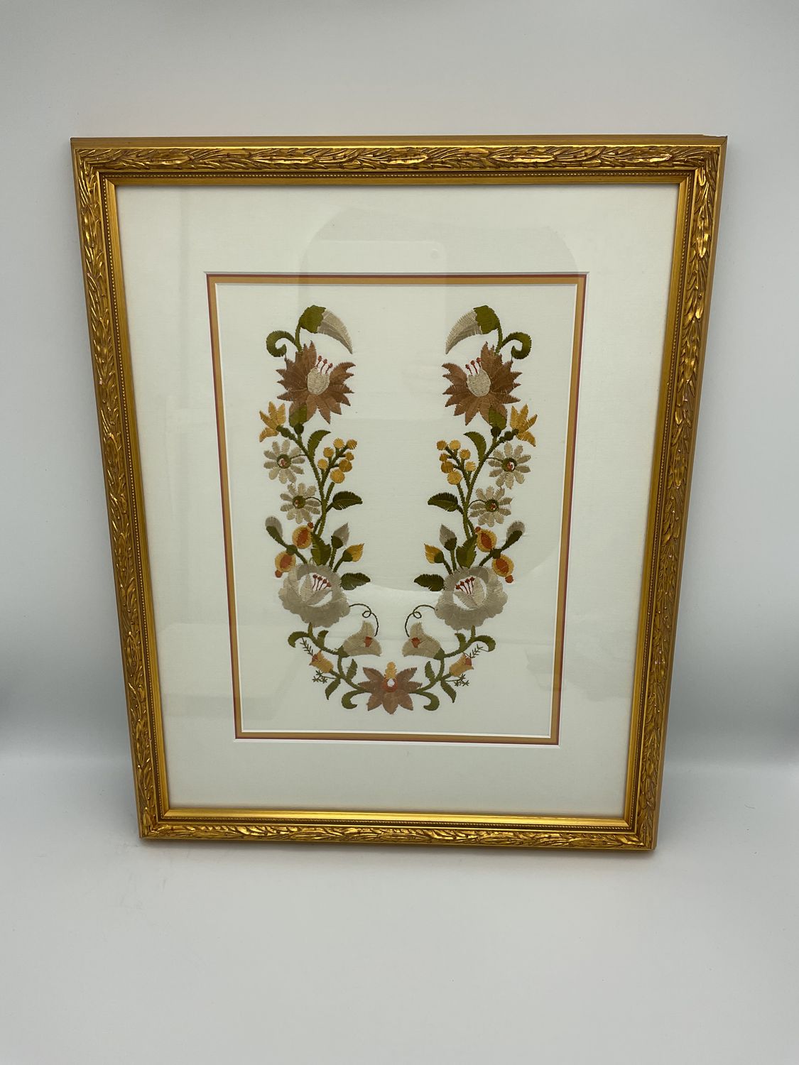 Floral embroidery in gold frame