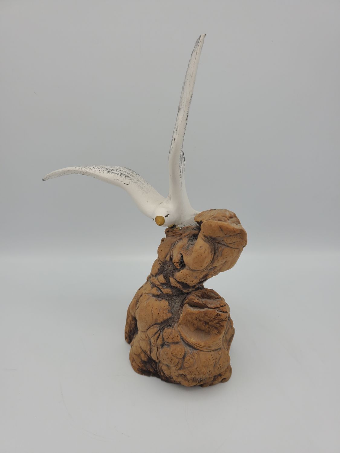 Seagull ceramic figurine on driftwood