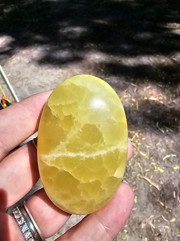 Yellow calcite palm stone