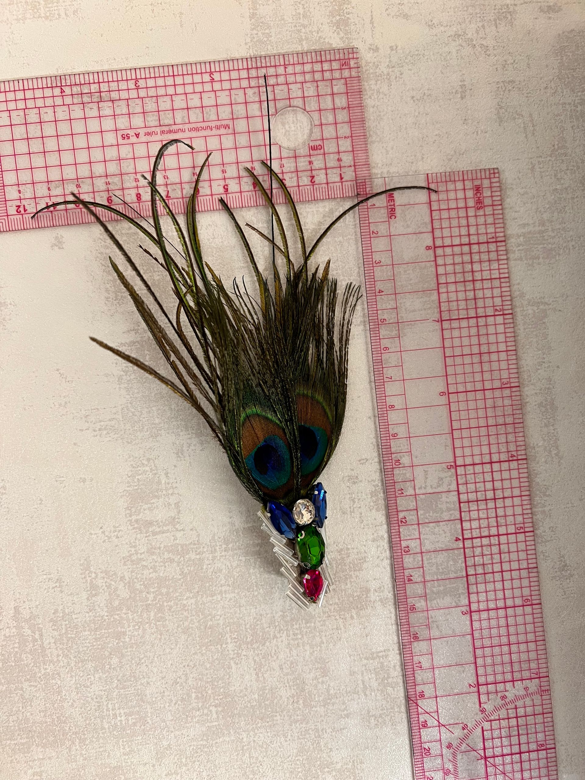 Broach pin with peacock feather