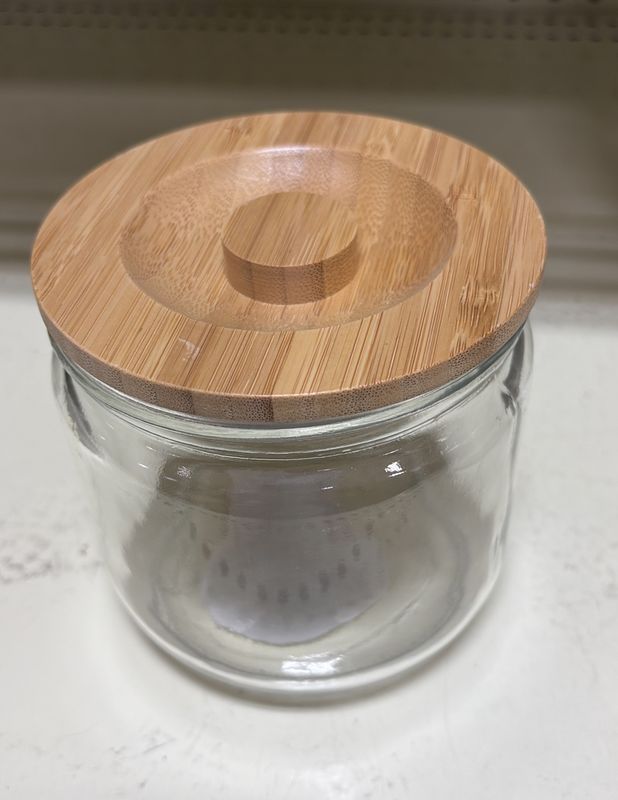 Wooden lid glass container .