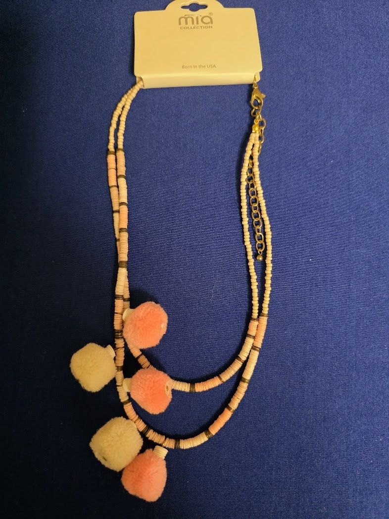 Mia Collection peach and cream beaded necklace featuring pom-poms