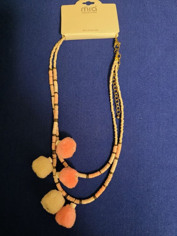 Mia Collection peach and cream beaded necklace featuring pom-poms