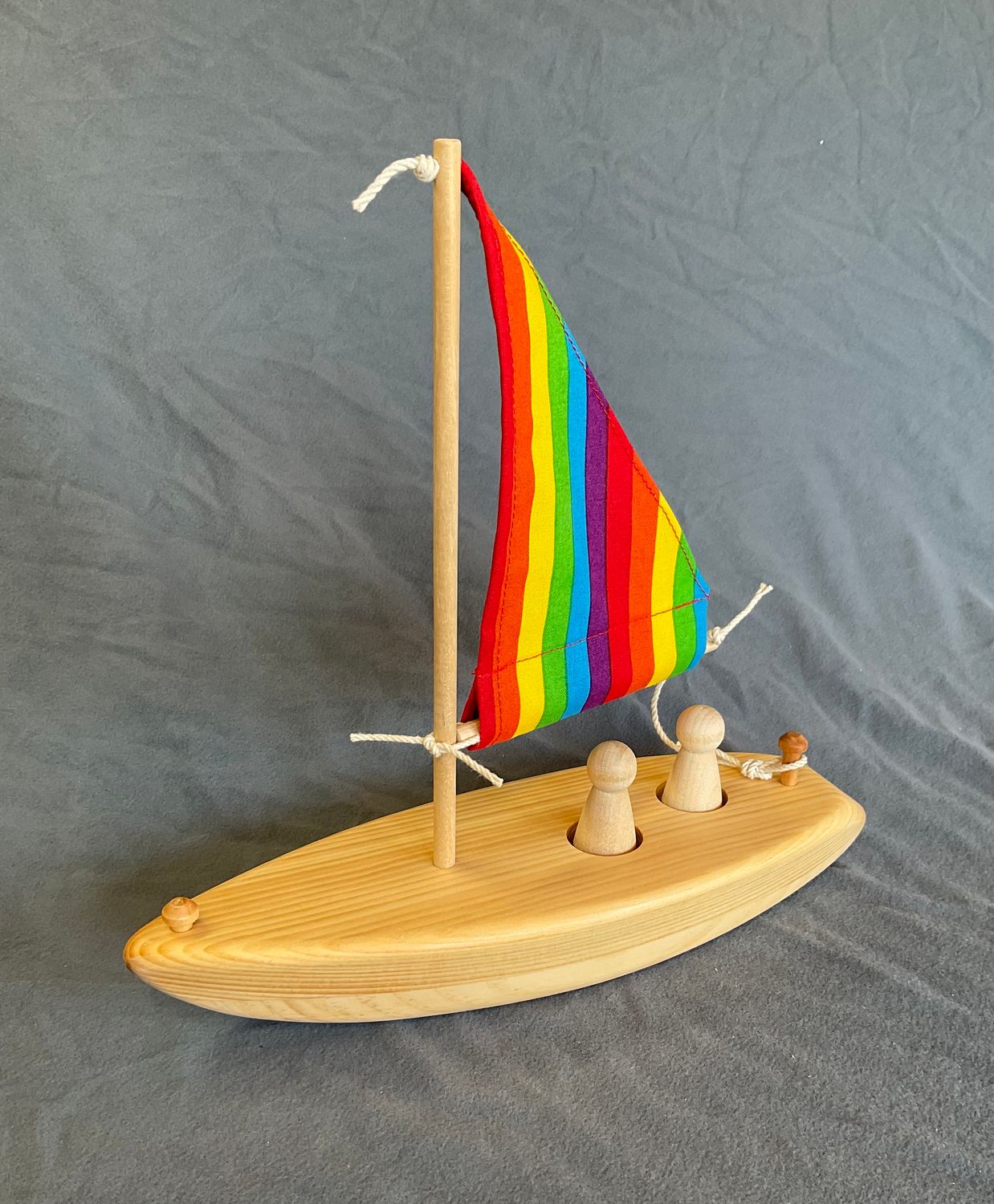 wooden toy sailboat, rainbow sail