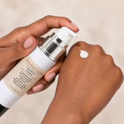 Botanically Clear Vitamin C Cream being dispensed onto a hand from an airless pump bottle