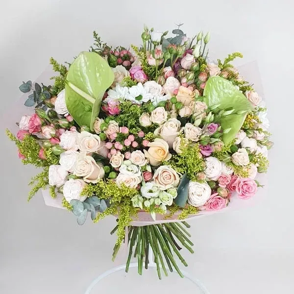 The bouquet is created with a mix of flowers and green anthurium.