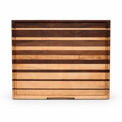 Handcrafted walnut and maple cutting board with graduated stripe pattern for kitchen food prep