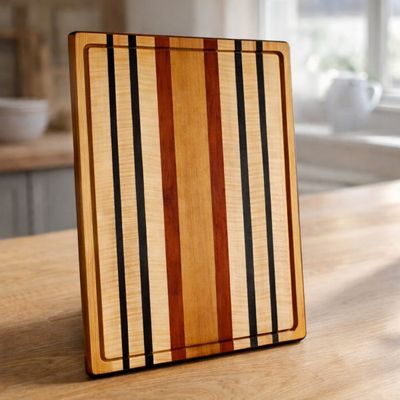 Mahogany, Ribbon Maple, Padauk & Wenge Hardwood Cutting Board Mahogany, Ribbon Maple, Padauk, and Wenge hardwood cutting board by Northern Rustic Wood.