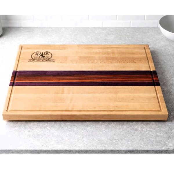 Maple cutting board with Purpleheart and Padauk center stripes and laser engraved logo.
