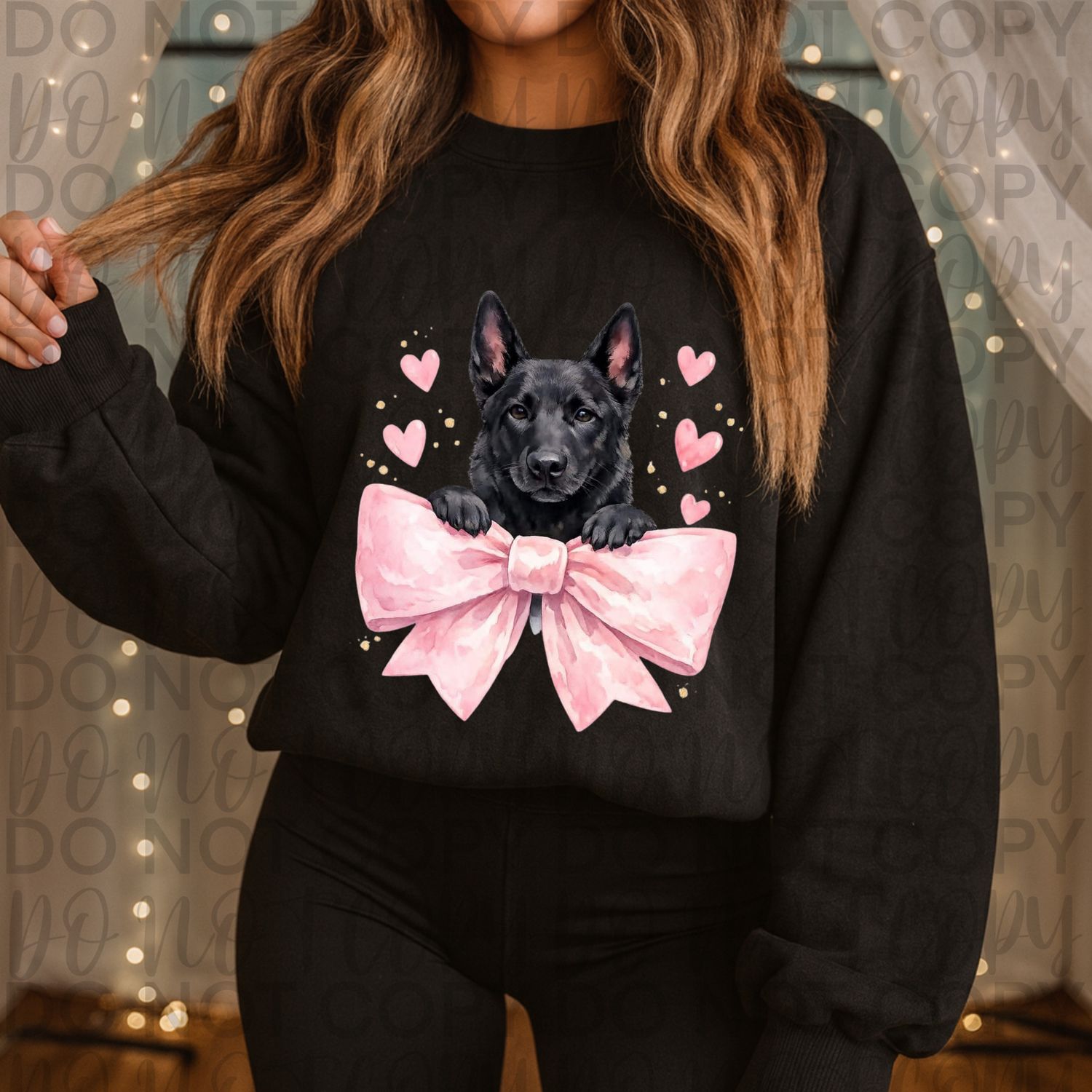 Black dog with pink hearts and a bow