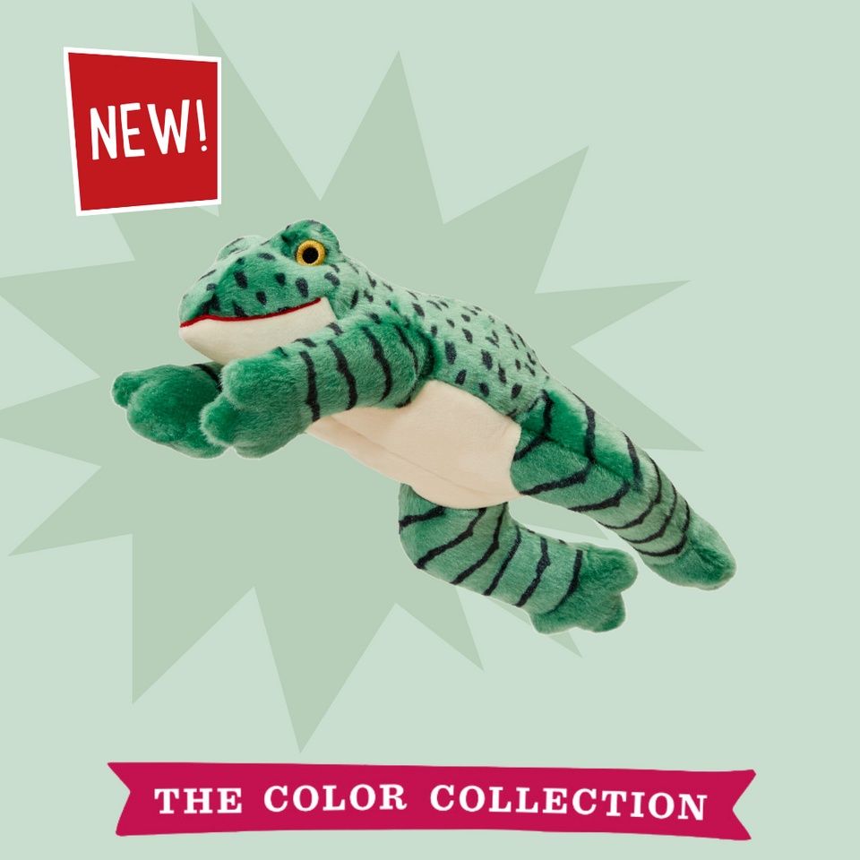 Plush frog dog toy mid-leap with wide grin