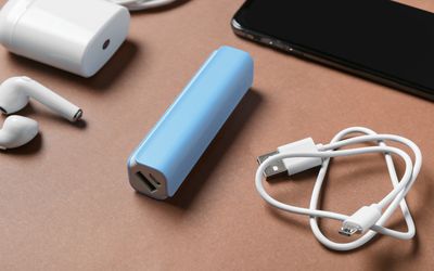 Assorted electronics accessories including chargers, cables, headphones, and phone mounts arranged in a smart lifestyle setup
