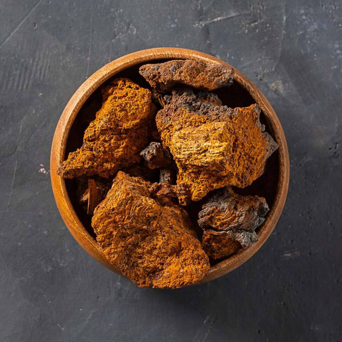 Wild-harvested chaga chunks in wooden bowl — organic birch chaga for brewing tea, Steel Ridge Farm