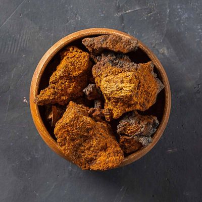 Wild-harvested chaga chunks in wooden bowl — organic birch chaga for brewing tea, Steel Ridge Farm