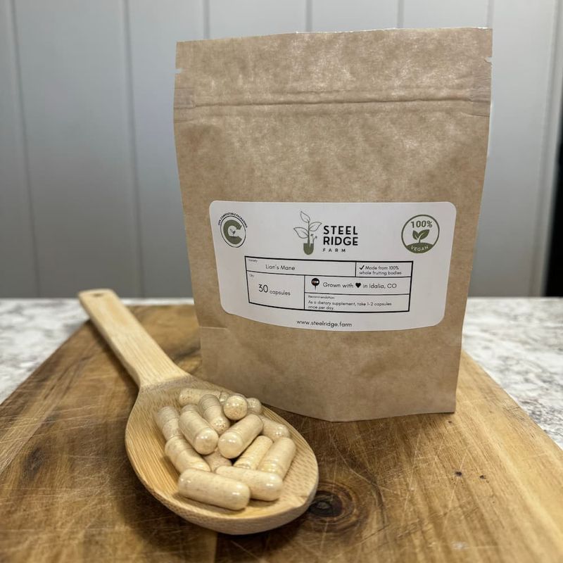 Lion's Mane Capsules in compostable kraft bag with wooden spoon — whole fruiting body, Steel Ridge Farm, Idalia, CO