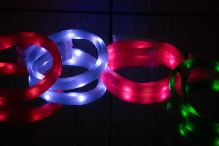 Close-up of the Rocky Mountain Dog Mountain Beacon LED Safety Collar, glowing in the dark with 360-degree illumination, showcasing its adjustable fit and durable design.

