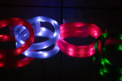 Close-up of the Rocky Mountain Dog Mountain Beacon LED Safety Collar, glowing in the dark with 360-degree illumination, showcasing its adjustable fit and durable design.

