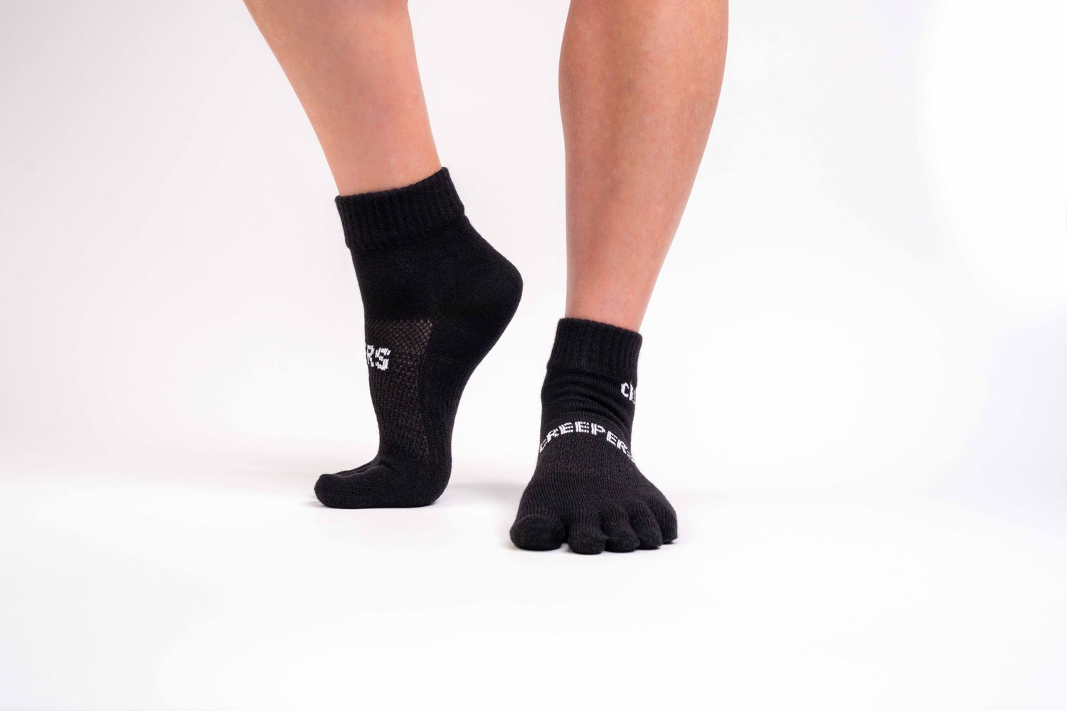 Black merino wool quarter-crew toe socks with anatomical design

