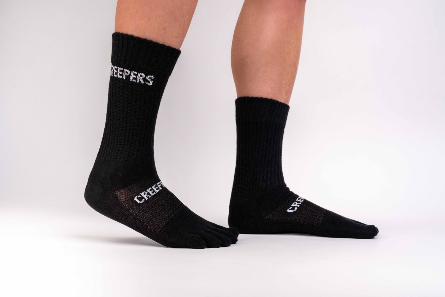 Black crew-height merino toe socks with ribbed leg and anatomical fit